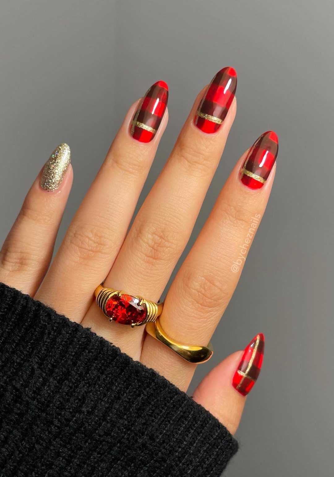 Red plaid nails with gold glitter.