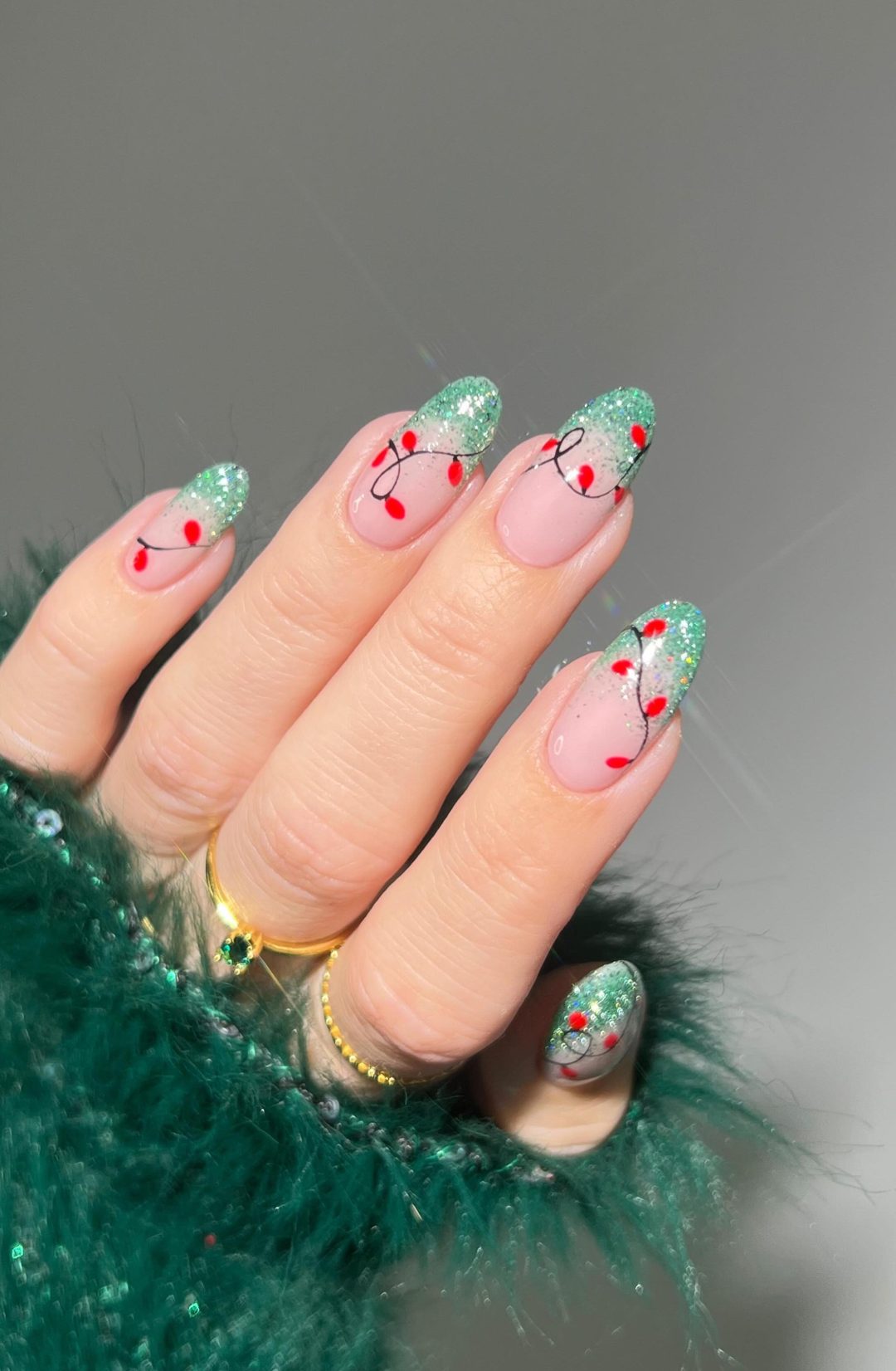 Mint green French tip nails with Christmas lights.