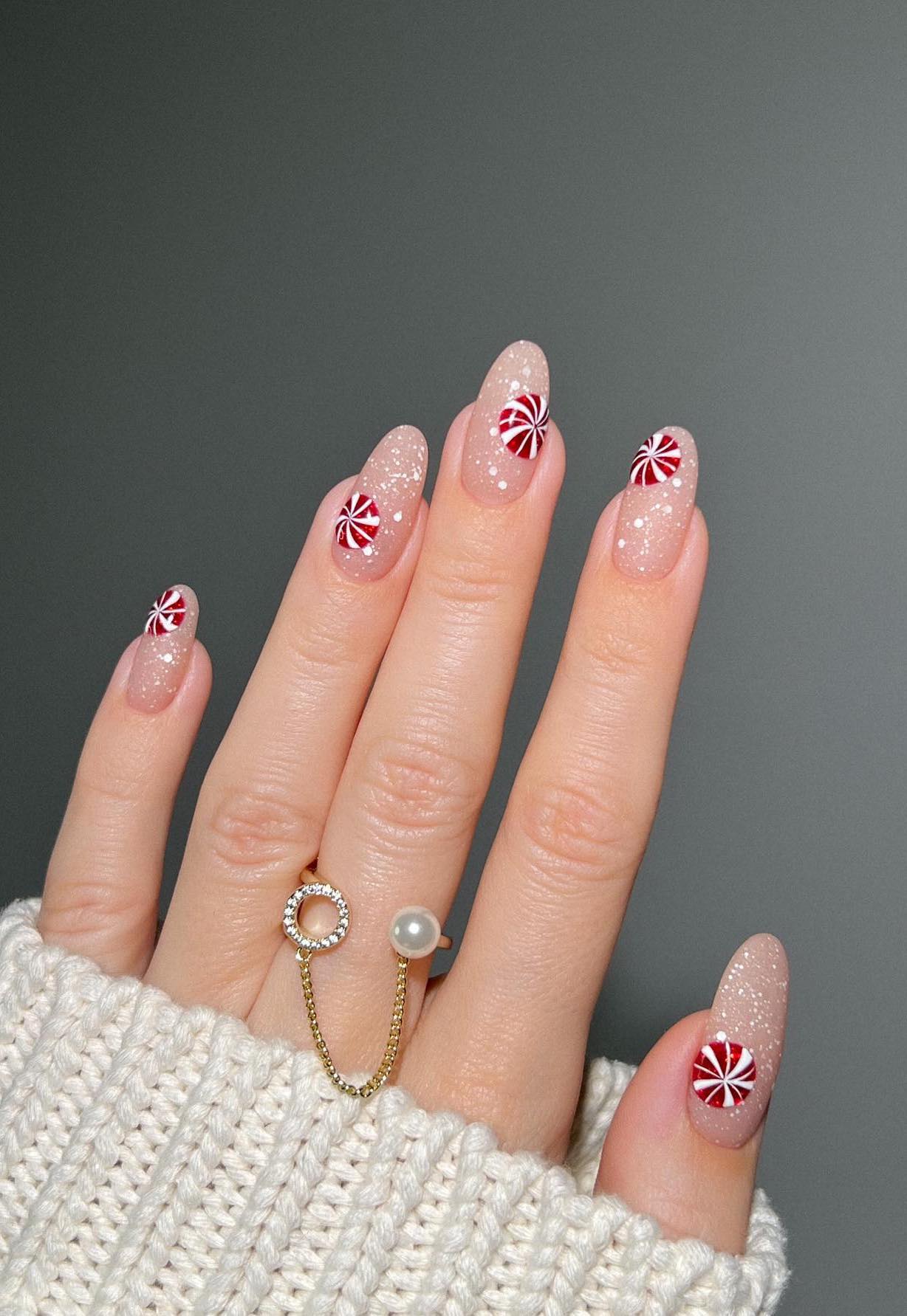 White Christmas nails with a candy cane design.