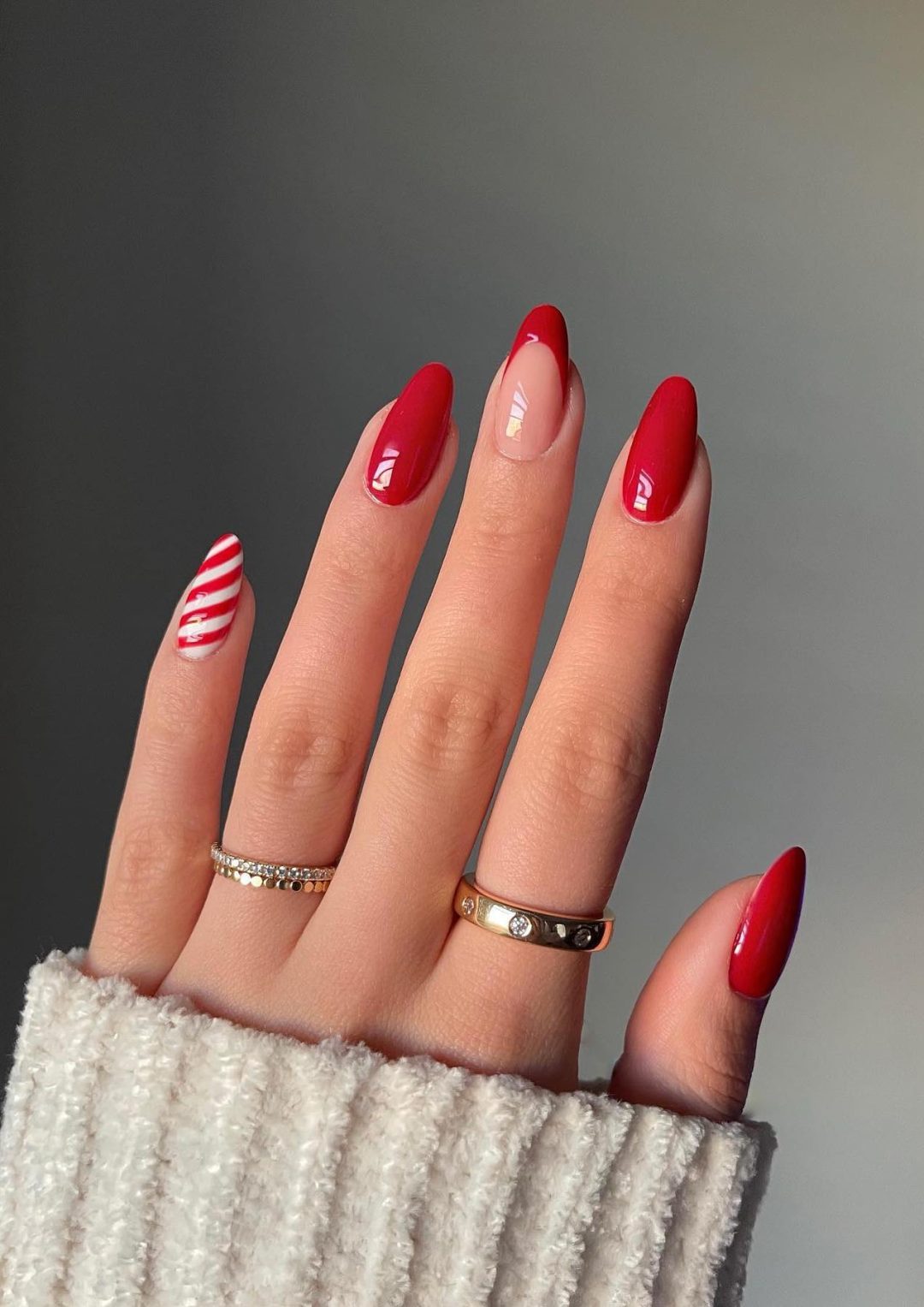 Red Christmas nails with candy cane nail art.