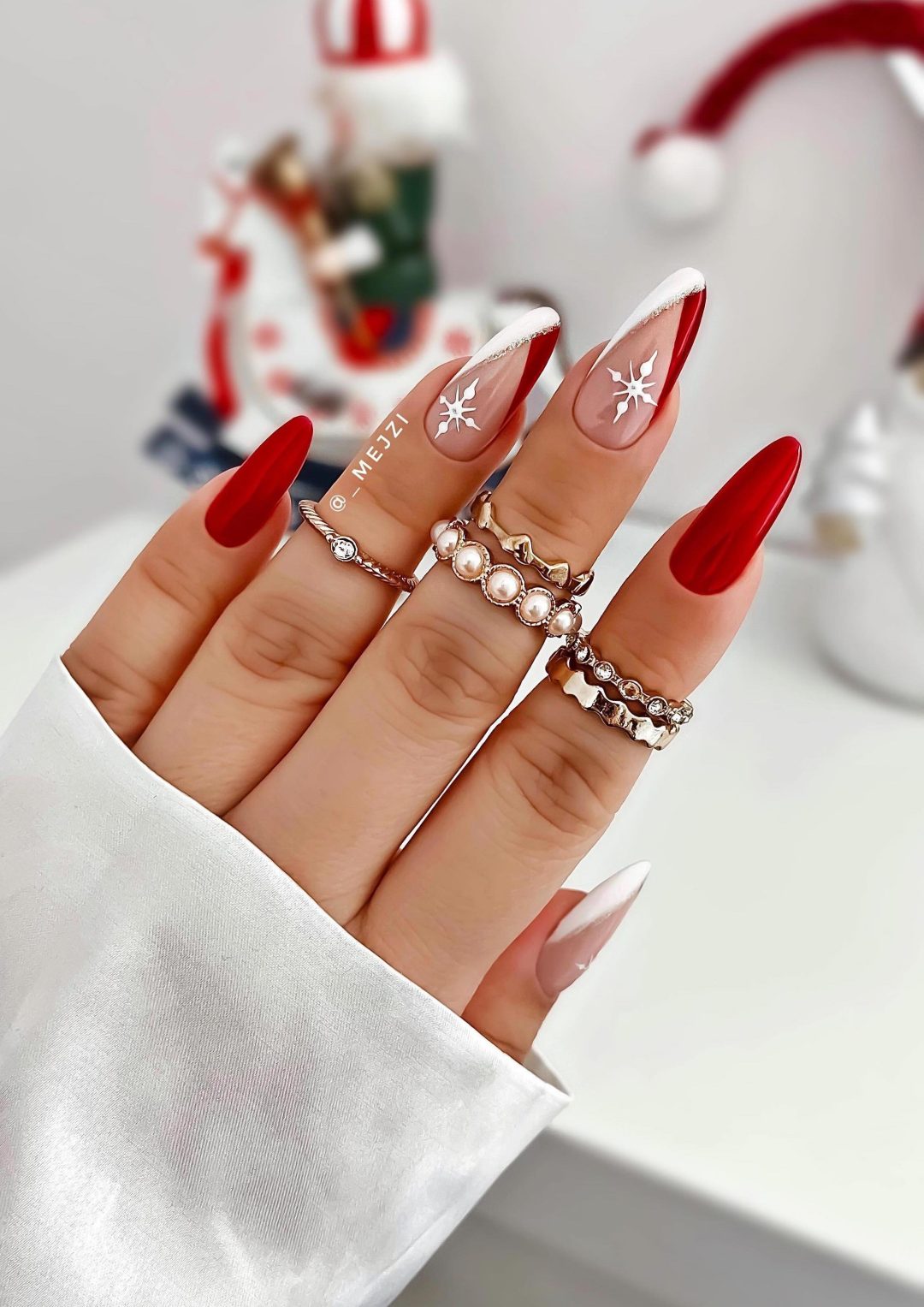 Red and white Christmas nails with snowflakes.