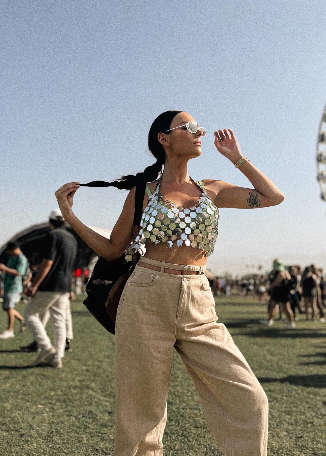 Chic Coachella look with silver sequin top and cargo pants.