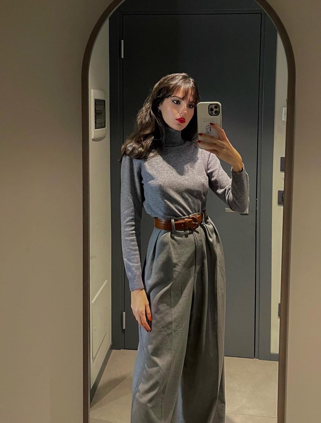 Cozy dark academia outfit with grey turtleneck and grey wide leg pants.