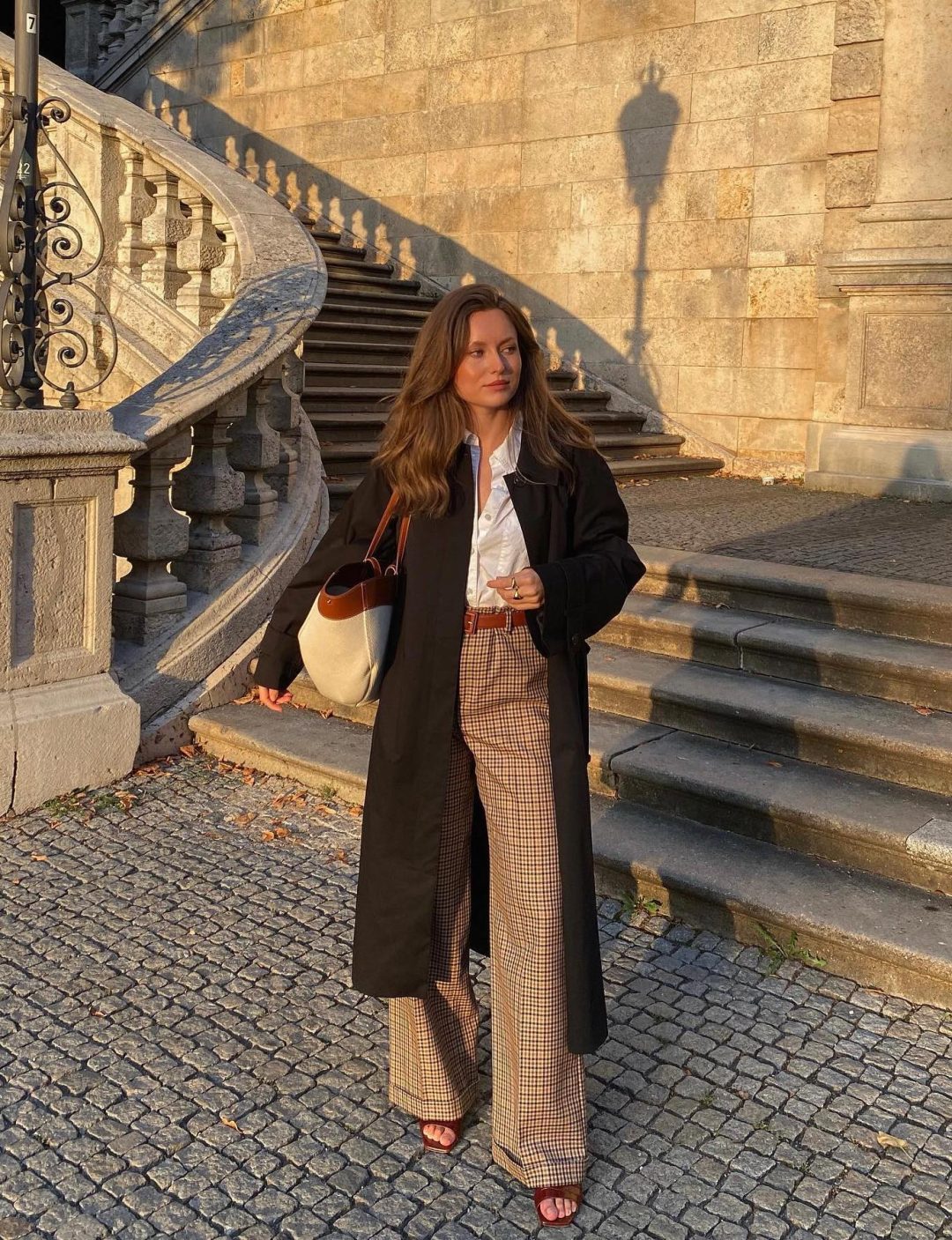 Chic dark academia outfit with black trench coat.