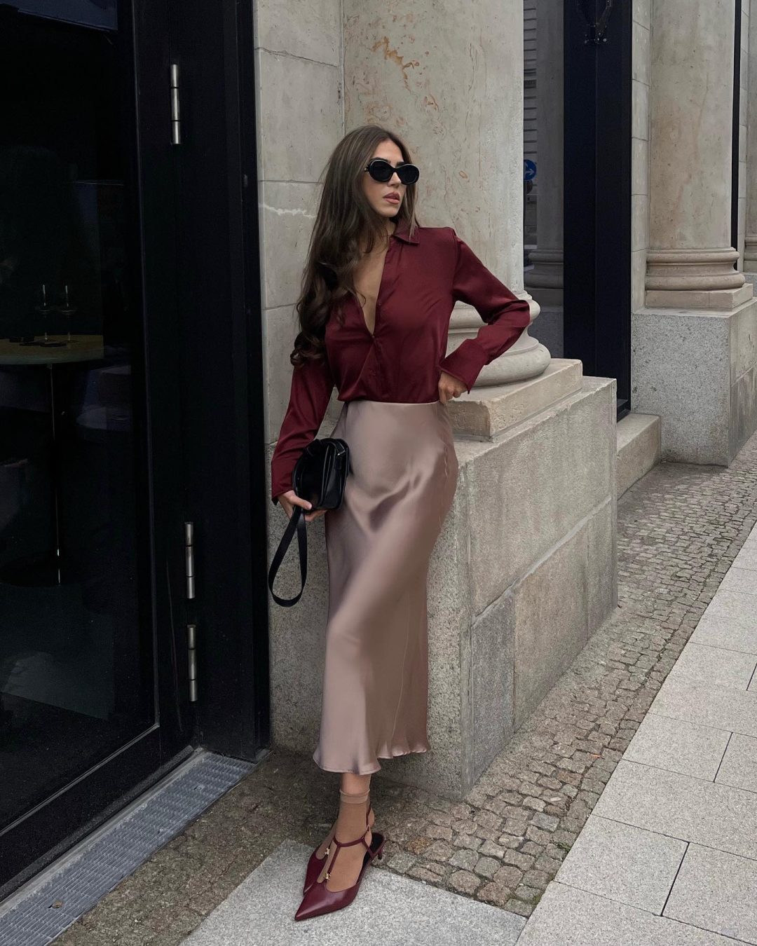 Beige satin skirt outfit with burgundy shirt.