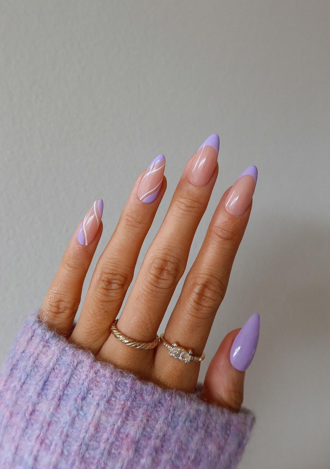 Light purple French tip nails with swirls.