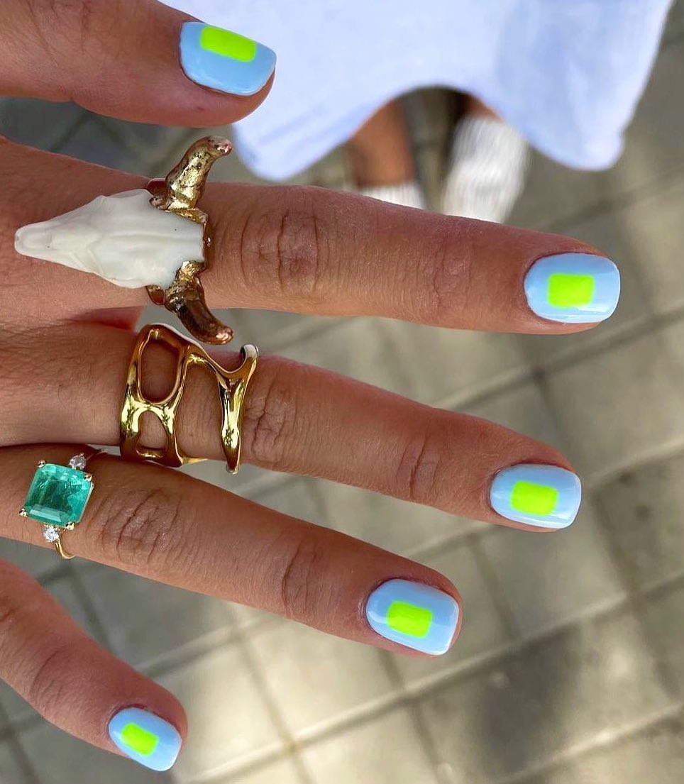 Short light blue nails with neon green.