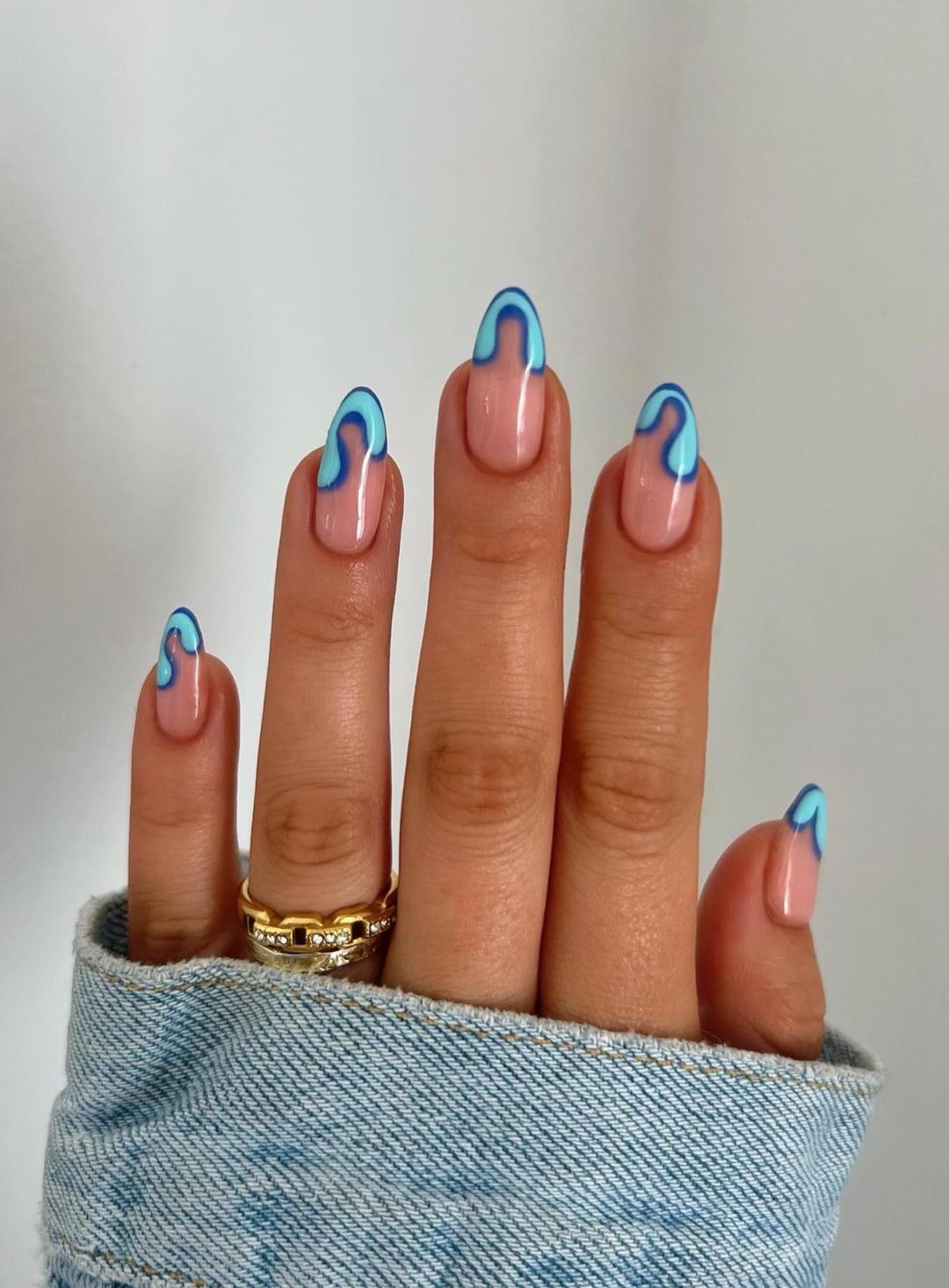 Abstract light blue French tip nails.