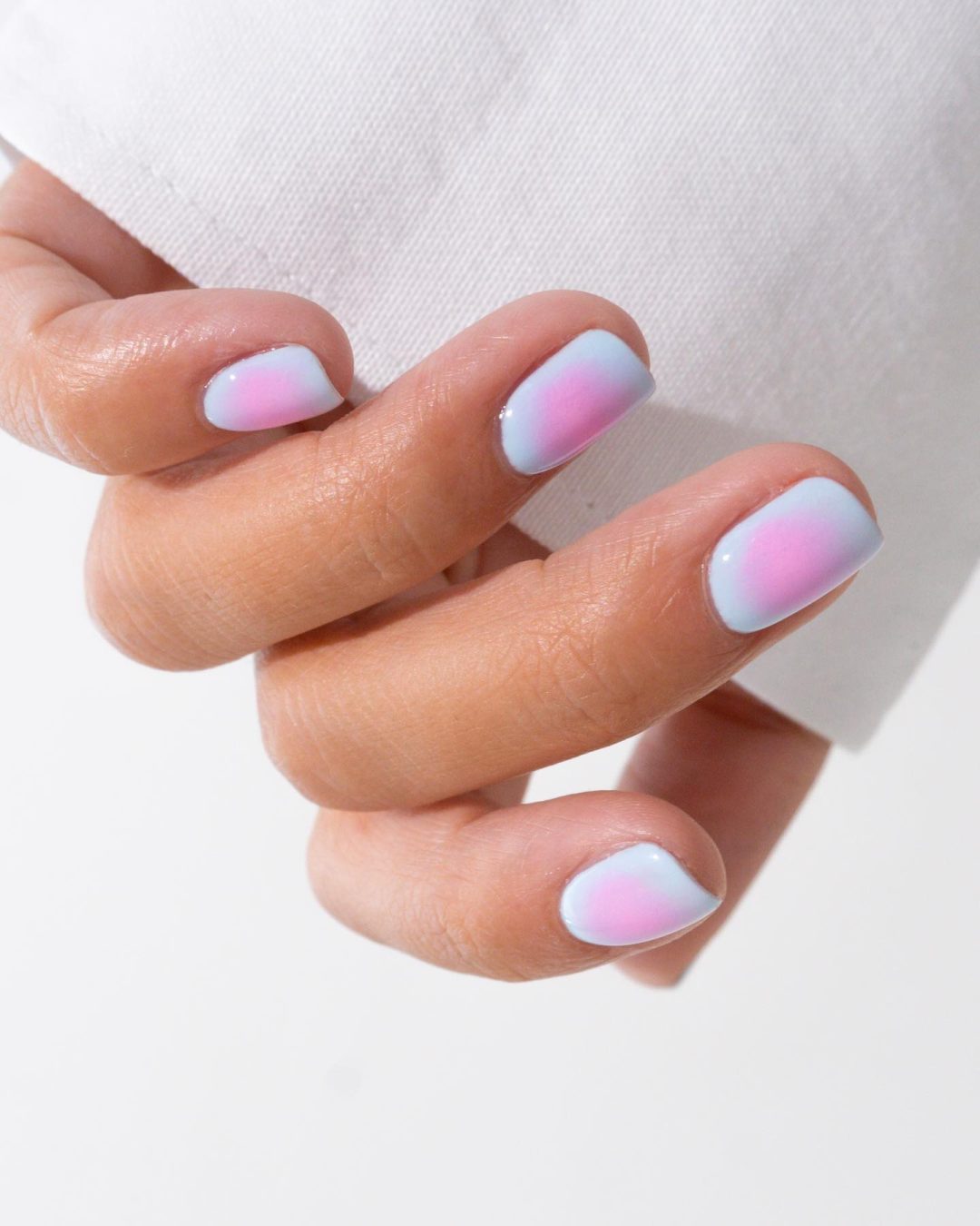 Short light blue and pink nails.