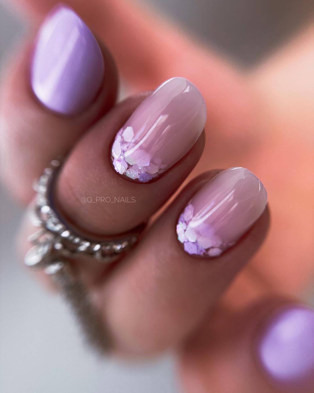 Light purple ombre nails with glitter sequins.