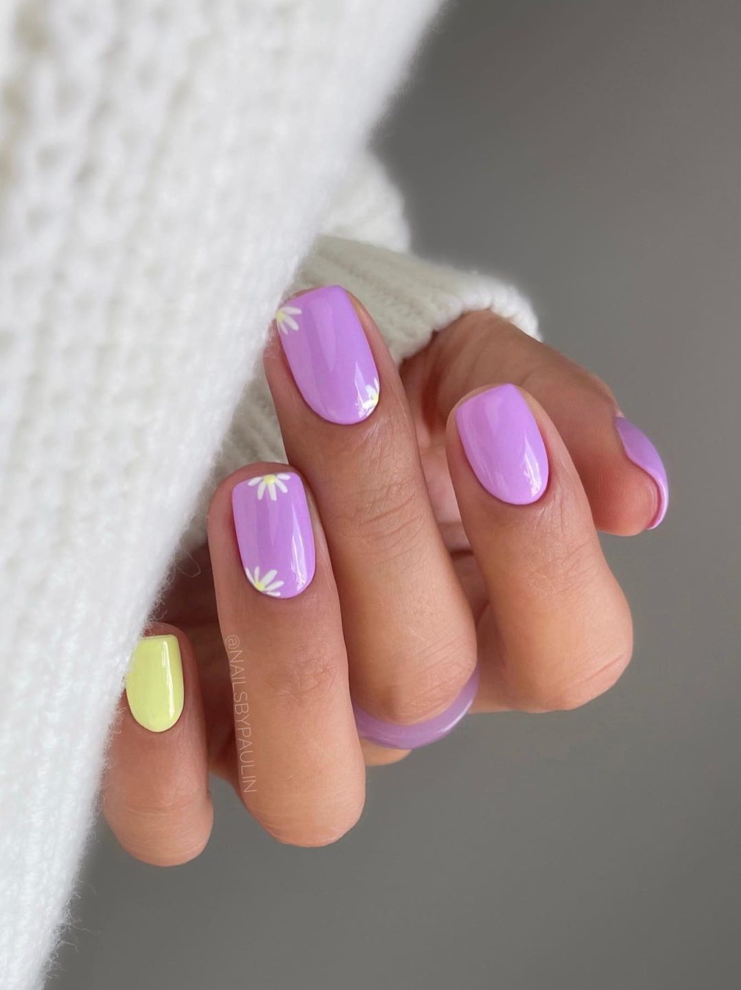 Light purple nails with a touch of pale yellow.