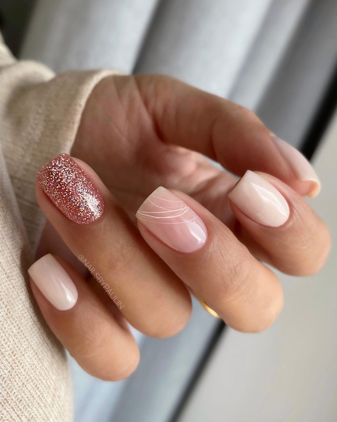 Neutral nails with rose gold glitter.