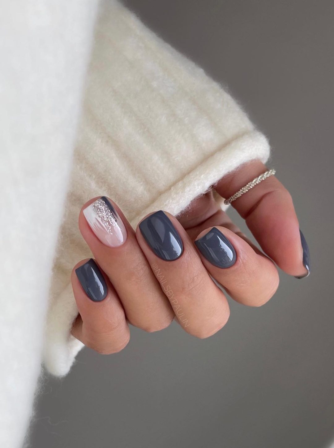 Short dark grey nails.