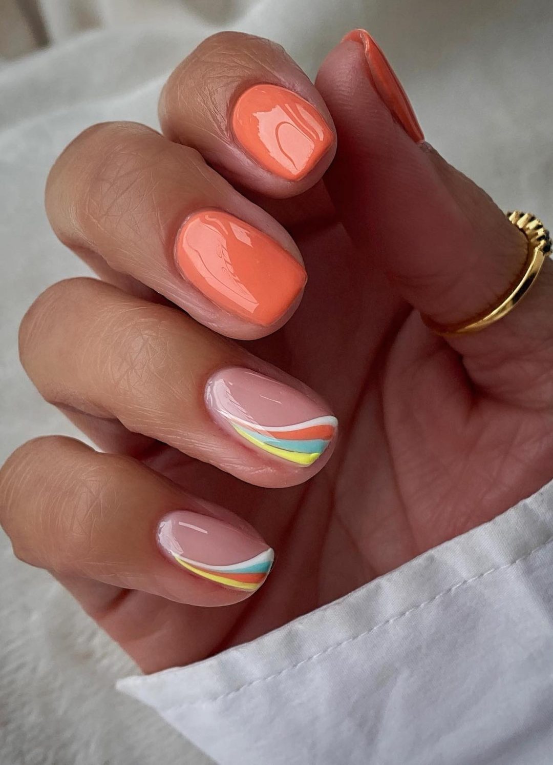 Orange nails with stripes.