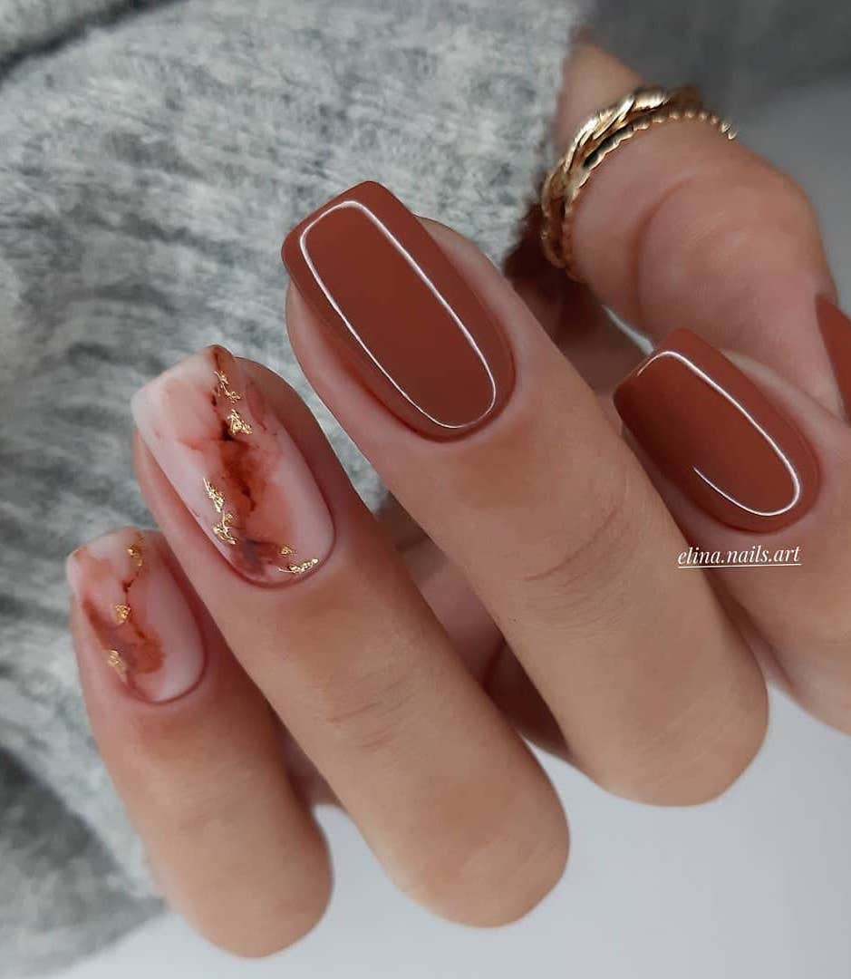 Brown nails with marble design.