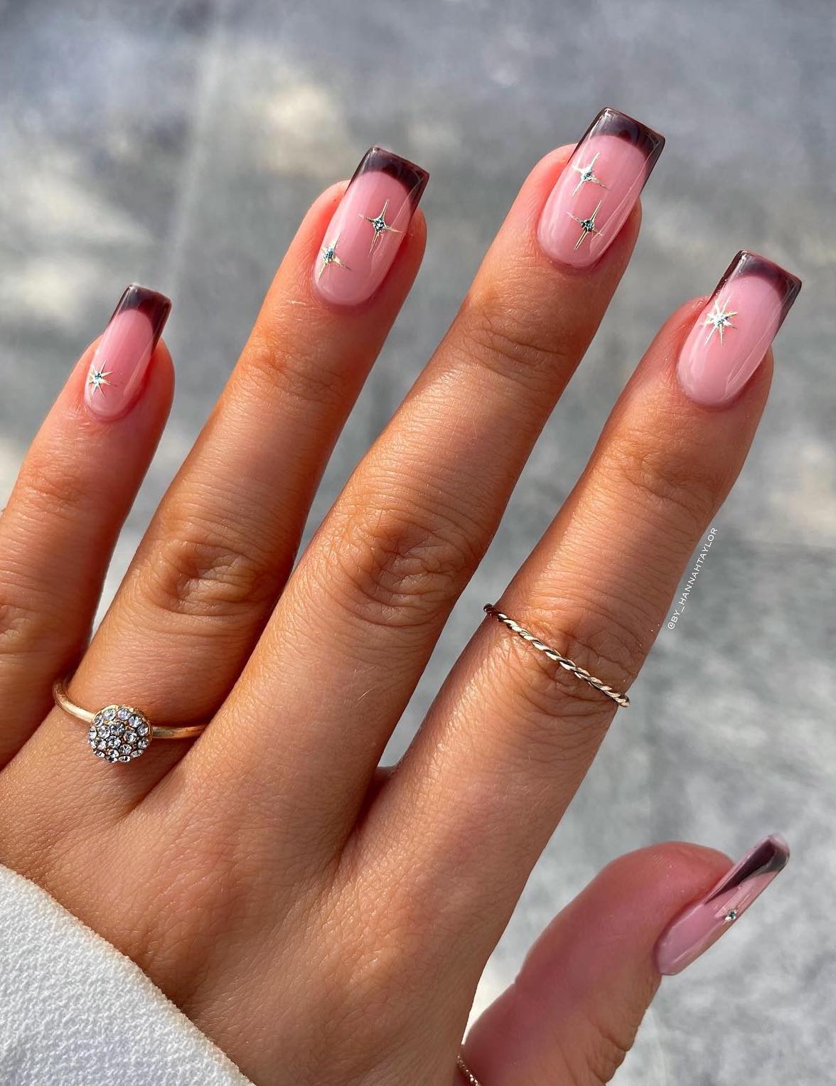 Brown French tip nails with stars.