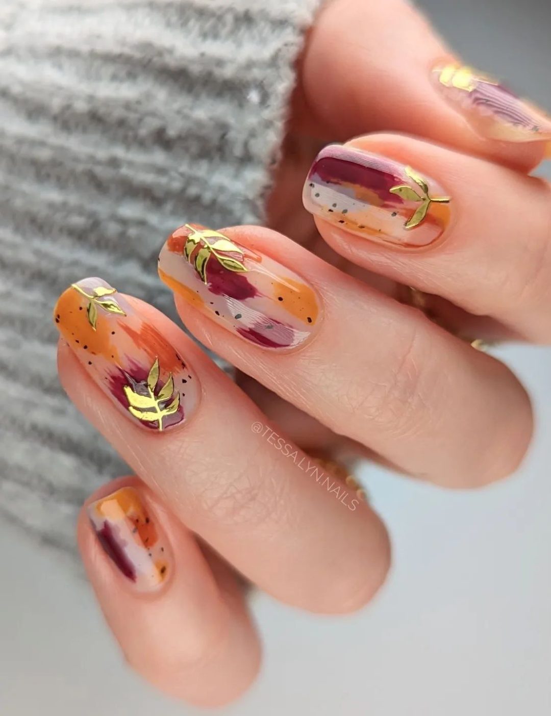 Burgundy and burnt orange abstract nails.