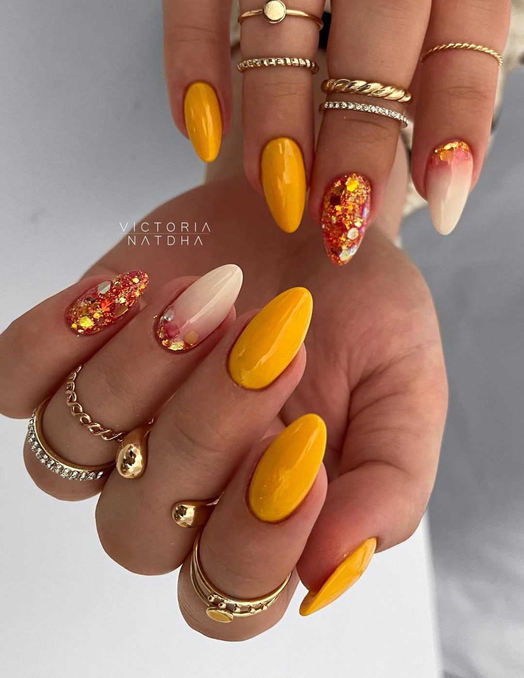 Mustard yellow Thanksgiving nails with glitter.