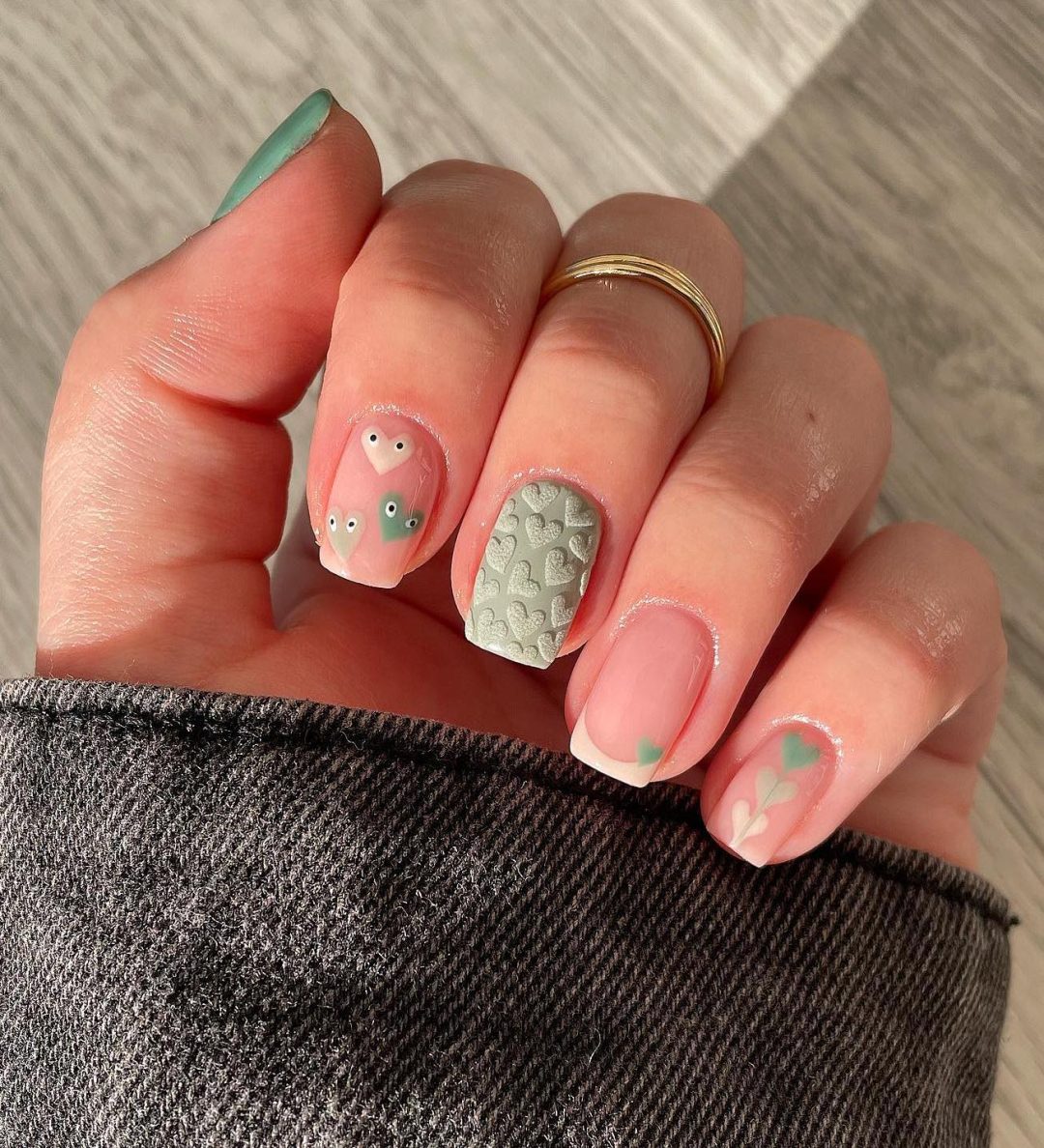 Short sage green heart nails.