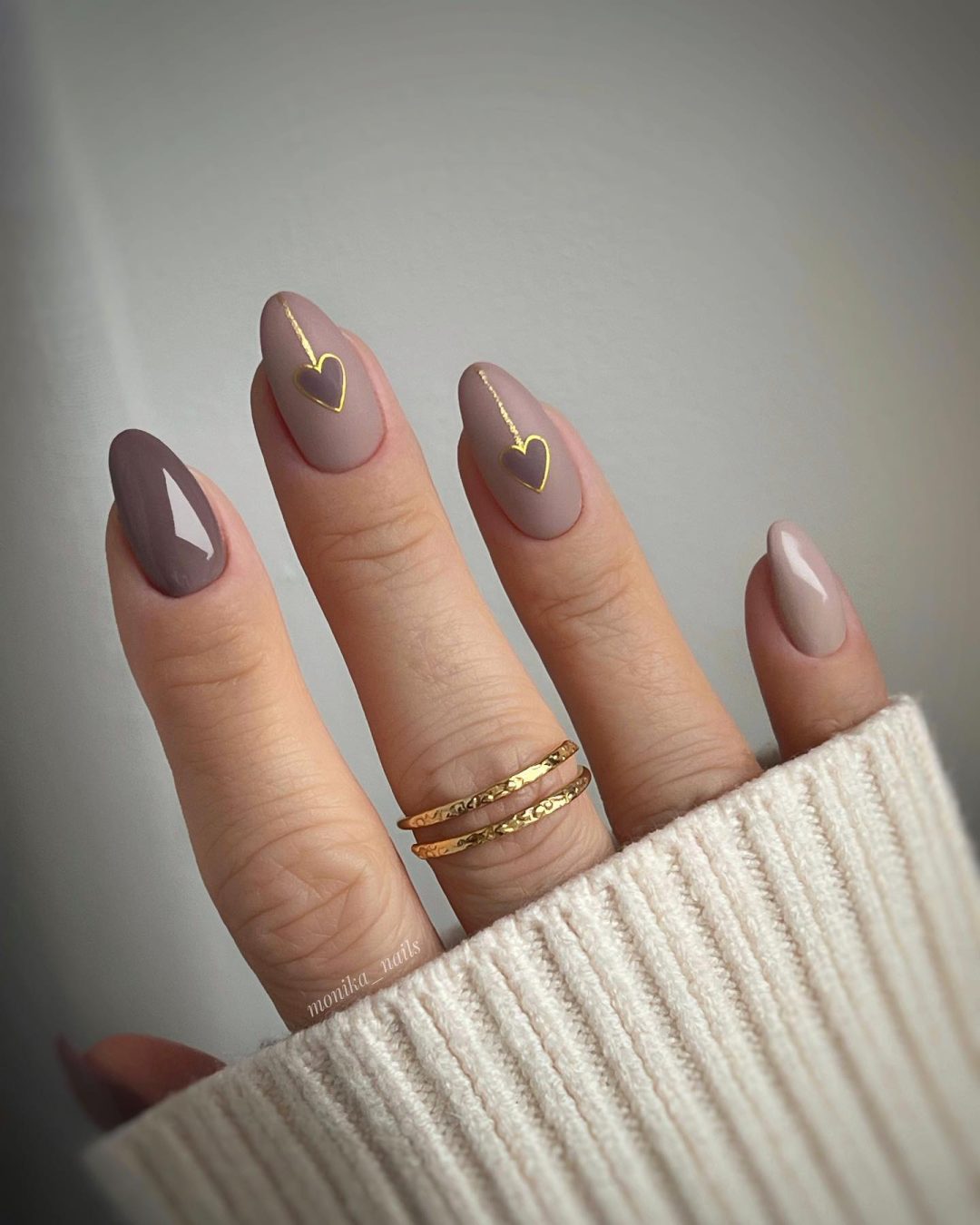 Matte neutral nails with hearts for Valentine's Day.