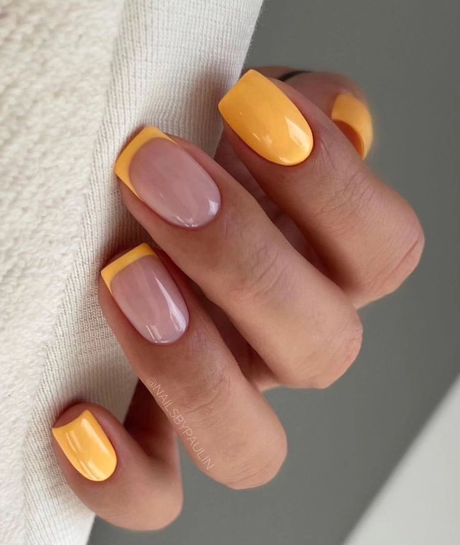 Pastel orange summer nails with French tips.