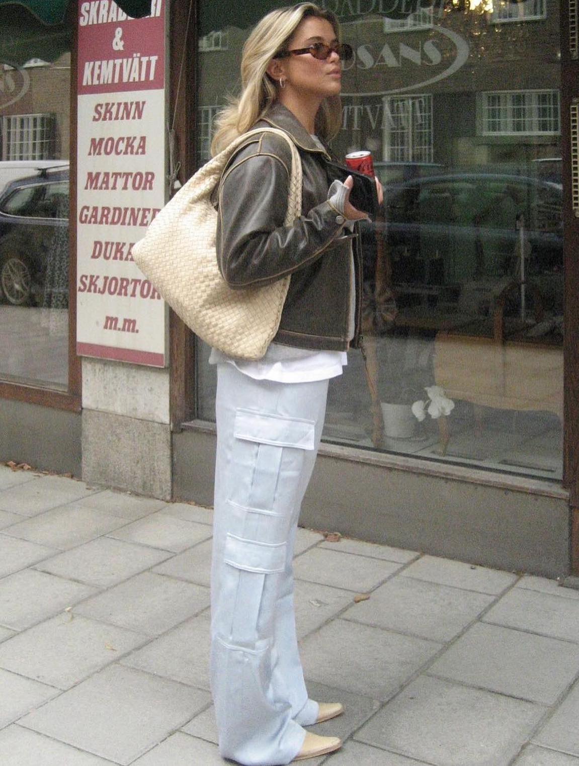 Casual outfit with white cargo pants and a leather jacket,