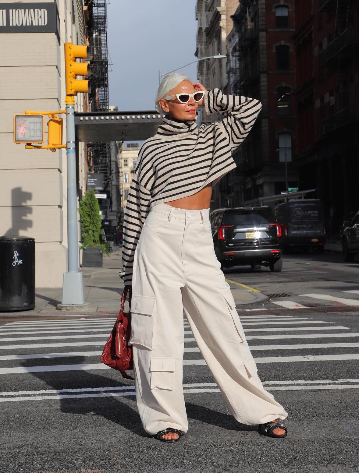 Chic, casual outfit with white cargo pants and a striped top.