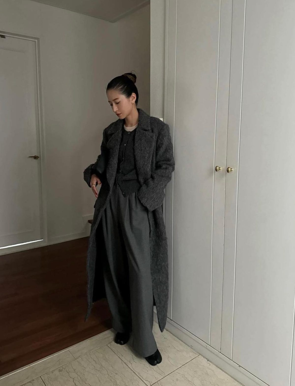 All grey outfit with wide-leg pants and a long coat