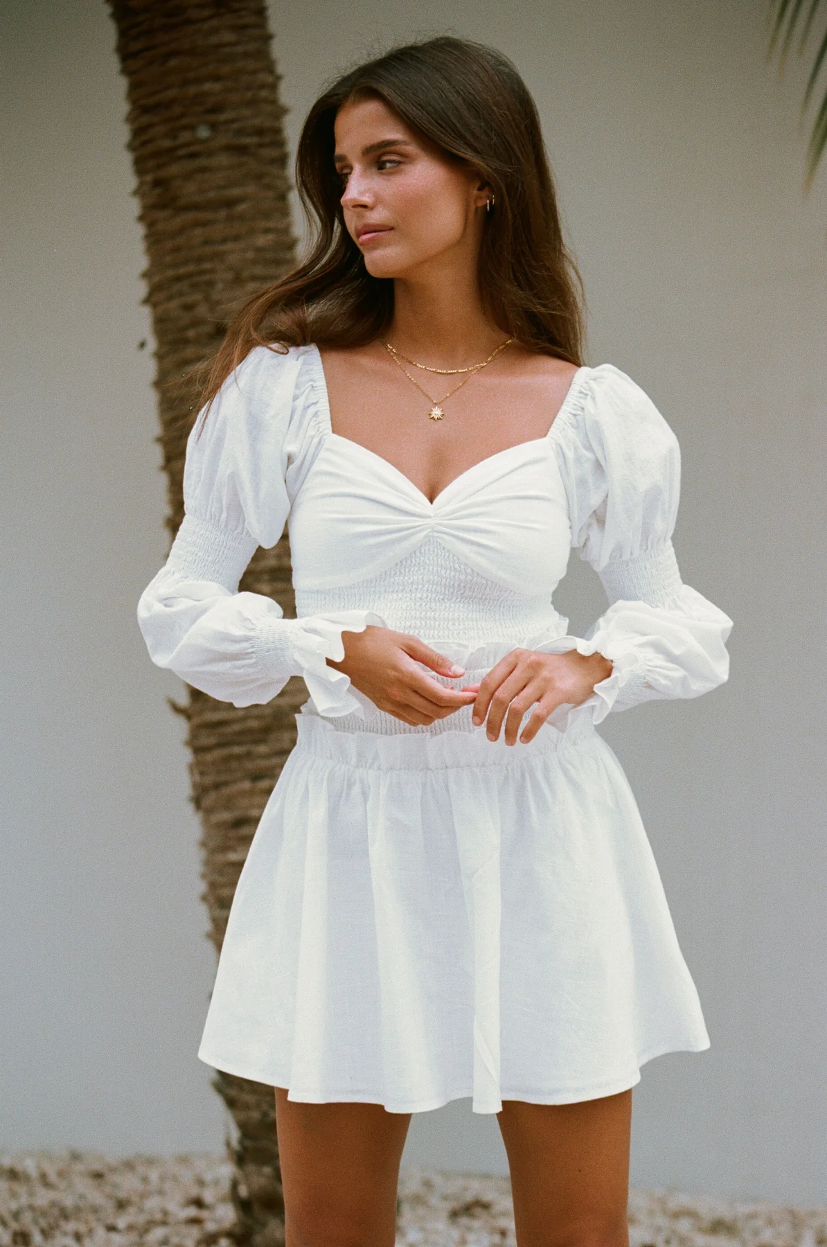 Cute white graduation dress with long sleeves.