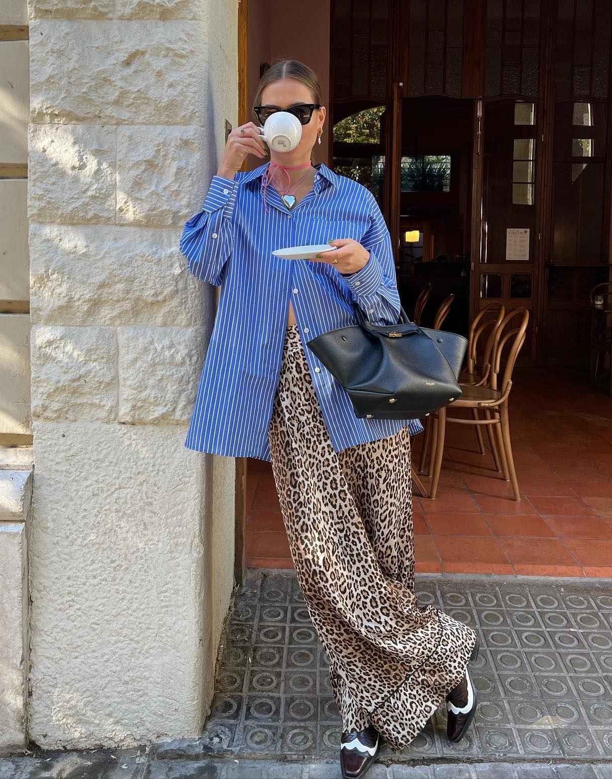 Wide-leg leopard print pants with a blue button-up shirt