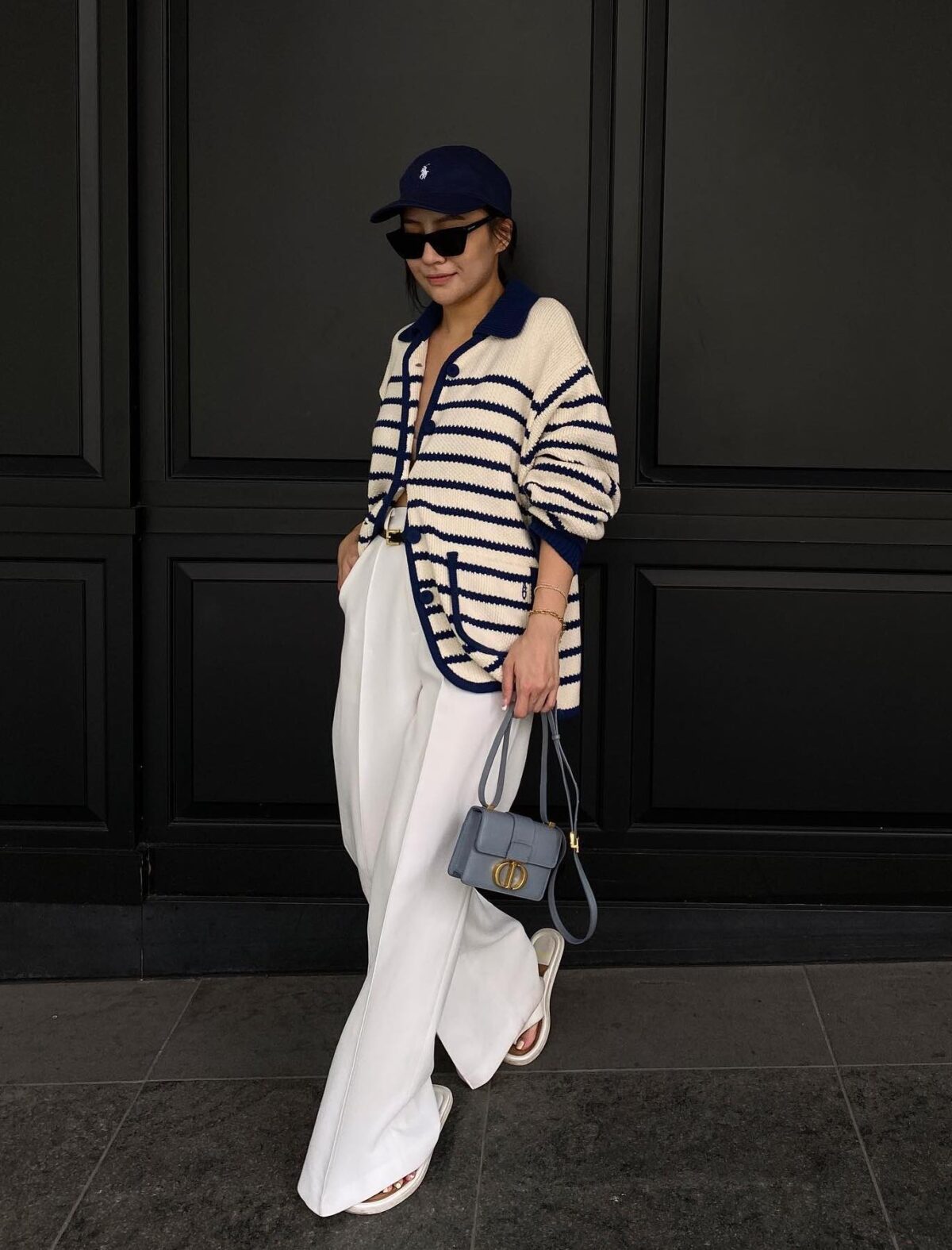 Casual outfit wth a striped cardigan white baggy pants and a Dior Micro Montaigne bag