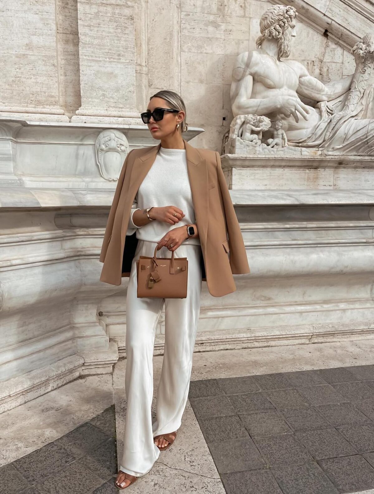 Chic fall outfit with white silk pants a white sweater and a camel blazer